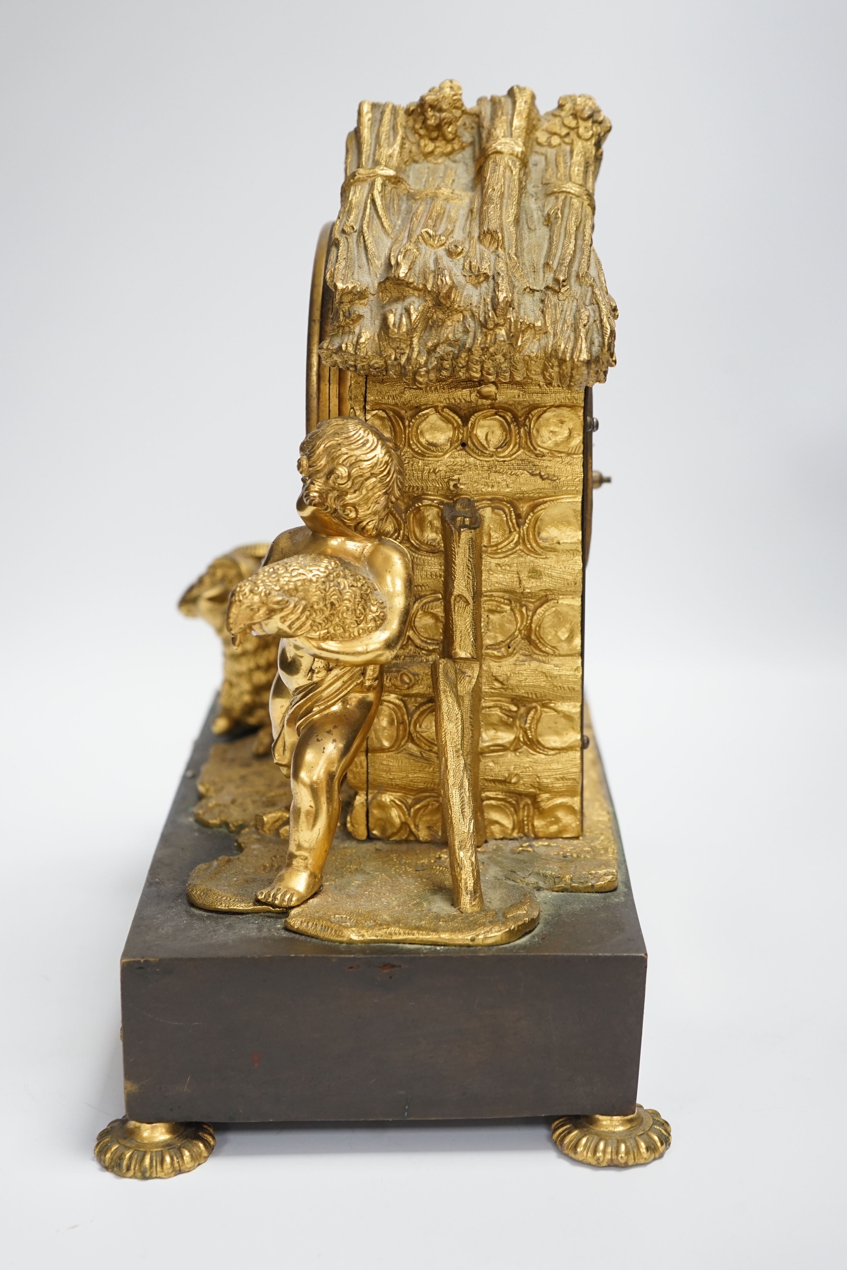 A 19th century ormolu clock, Richard & Cie stamped movement, case formed as a log cabin with child and sheep figural group, 30cm high